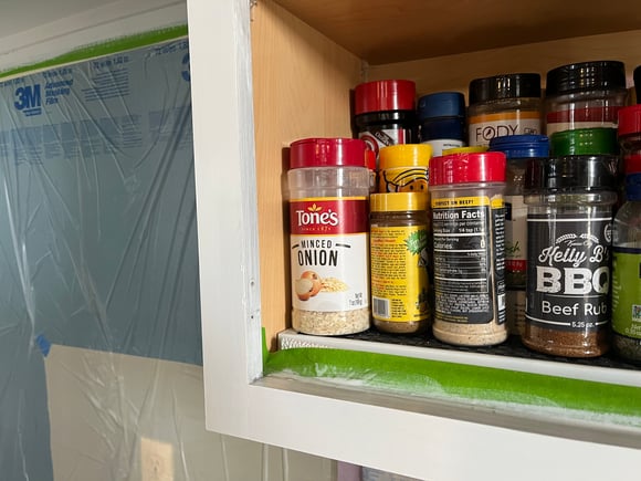 Spice shelf inside of a cabinet box with a shelf liner underneath.