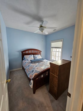 Bedroom painted a baby blue color with white ceiling and trim in Omaha, NE.