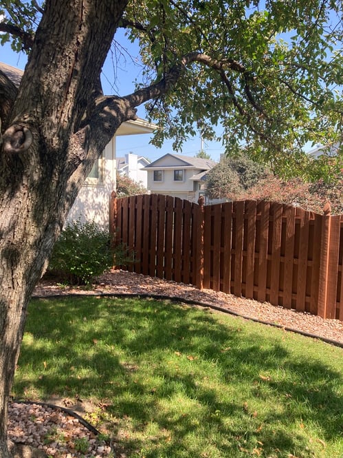 Shadowbox fence stained a warm redish brown color at a home in Omaha, NE.