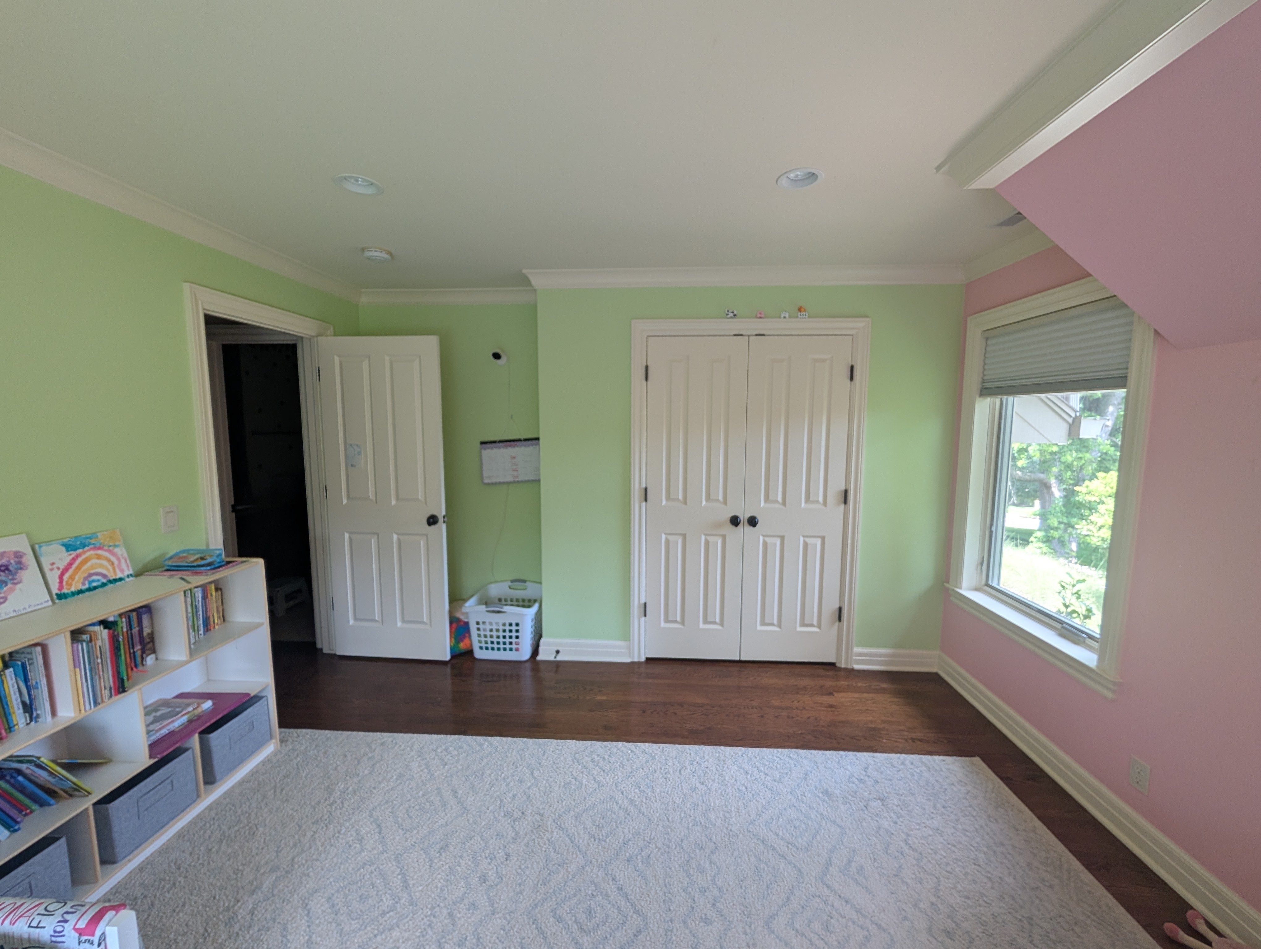 Girls bedroom painted a soft bright green and a baby pink color inside a home in omaha, NE.