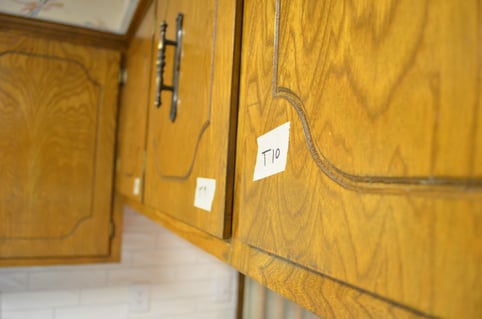 Oak cabinet door with tape that is labeled as "T10".