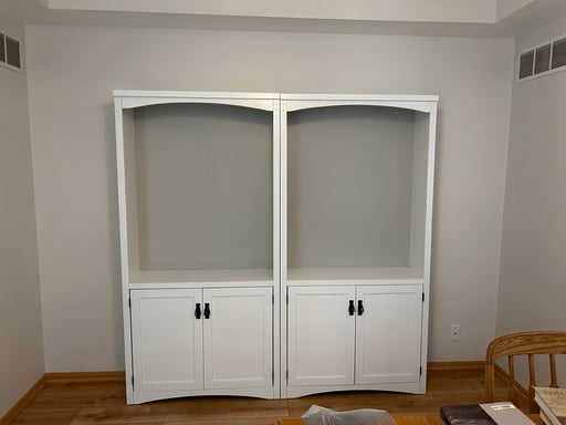Bookshelves painted white with black hardware inside a home in Omaha, NE.