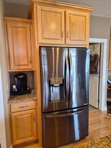 Cabinets around a fridge with a clear coat of a 2k polyurethane on them to keep them durable.