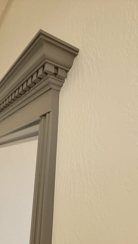 Porous wall texture inside a home painted white in omaha, ne with detailed window trim painted grey.