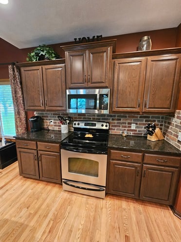 Kitchen cabinets around stove after toning / staining.