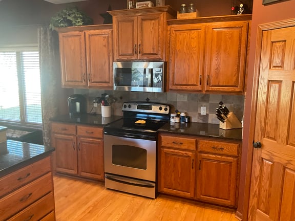 Cabinets around stove a golden oak wood before staining.