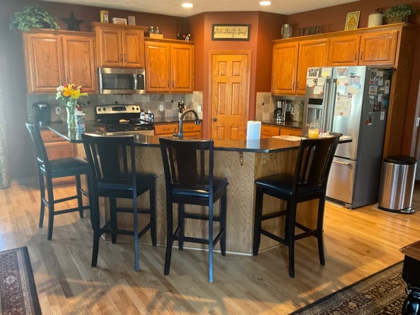 Golden oak cabinets in a kitchen before staining.