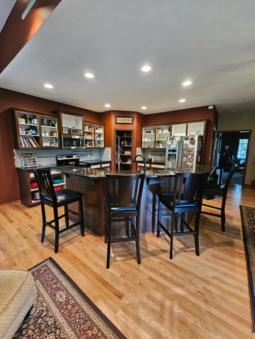 Kitchen cabinets in the process of being stained with the doors and drawer fronts removed.