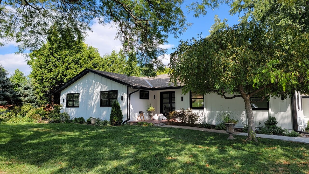 House in Omaha NE freshly painted white with black trim.