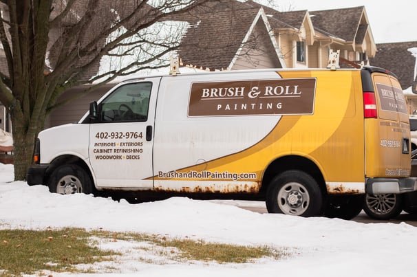 Brush & Roll Painting van in a driveway of a home in Omaha, NE for painting.