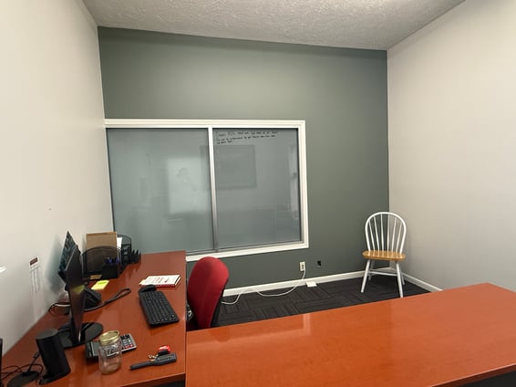 Office room with a grey accent wall.