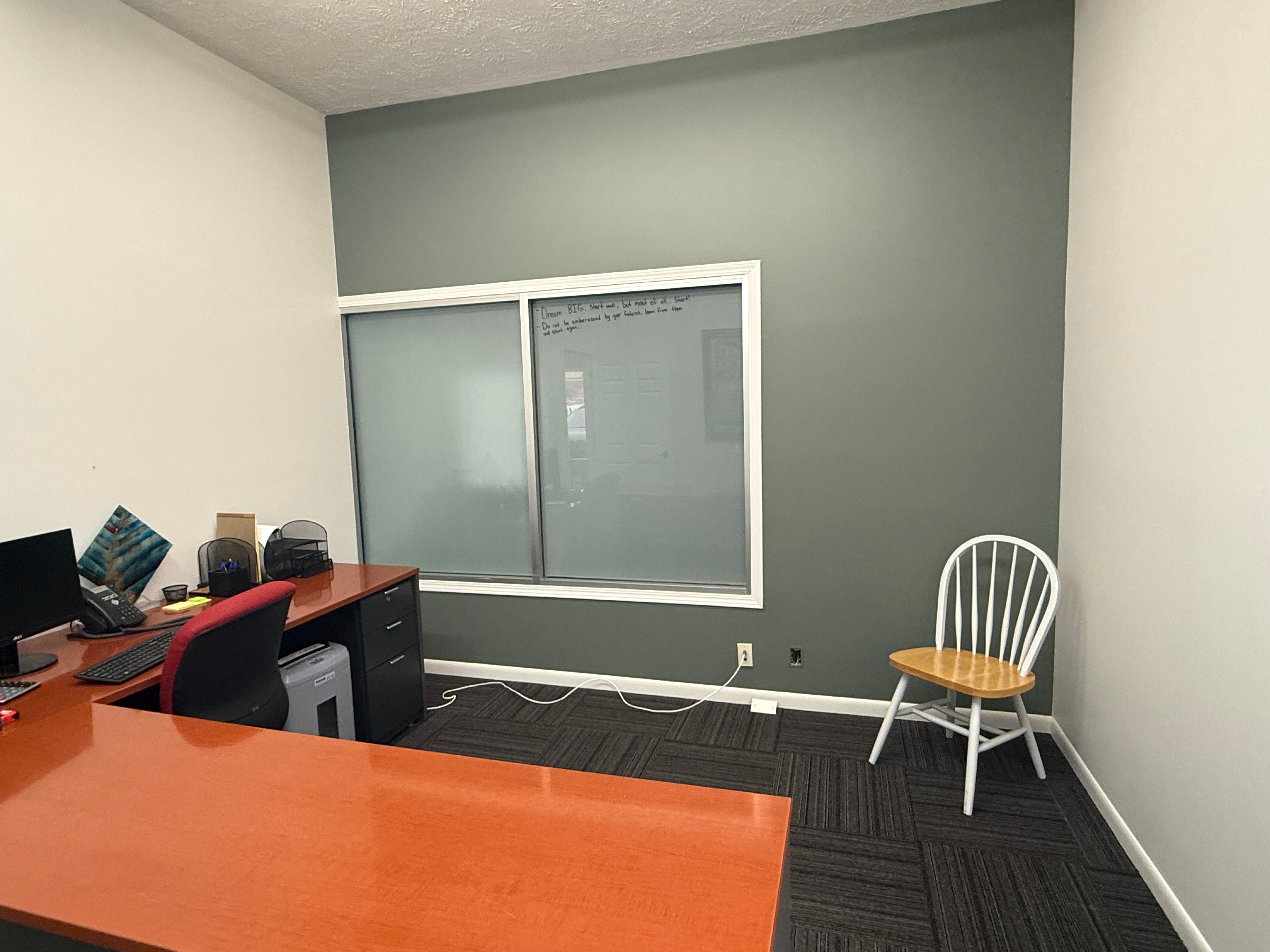 Office room with a grey accent wall at Brush & Roll Painting.