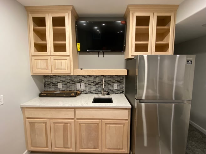 Natural wood oak doors and drawer fronts installed in basement kitchen ready to be painted.