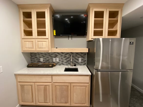 Kitchen with cabinet doors installed that are bare wood and need painted.