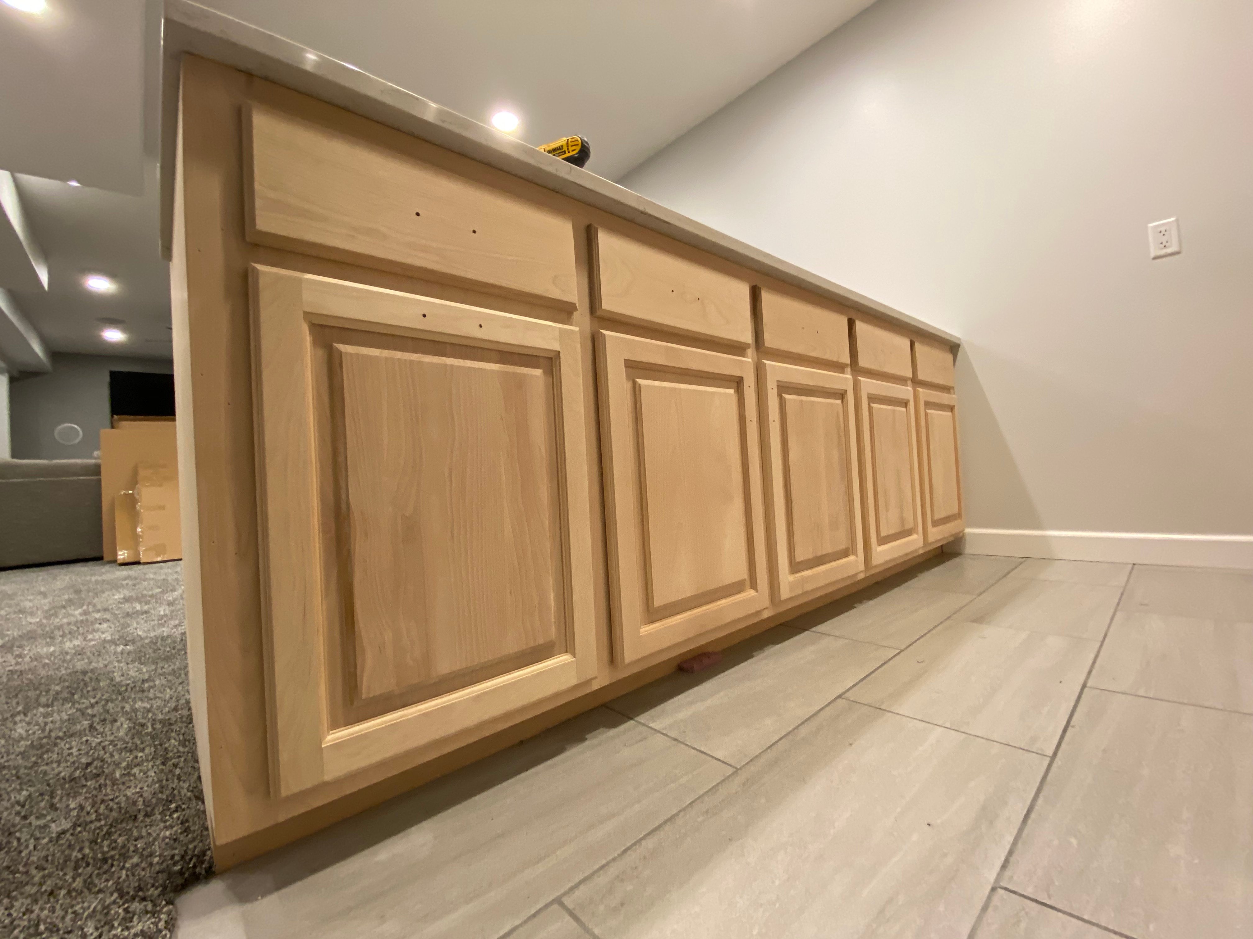 Natural oak wood cabinets in a basement kitchen before being painted in omaha, NE by Brush & Roll Painting.