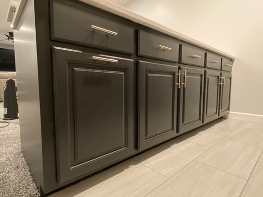 Black painted cabinets in a basement kitchen with silver handles in Omaha, NE.