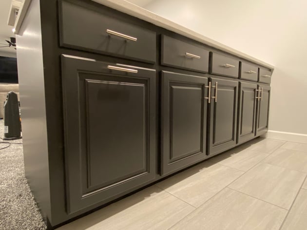 Dark lower cabinets with silver handles freshly painted black in Omaha, NE.