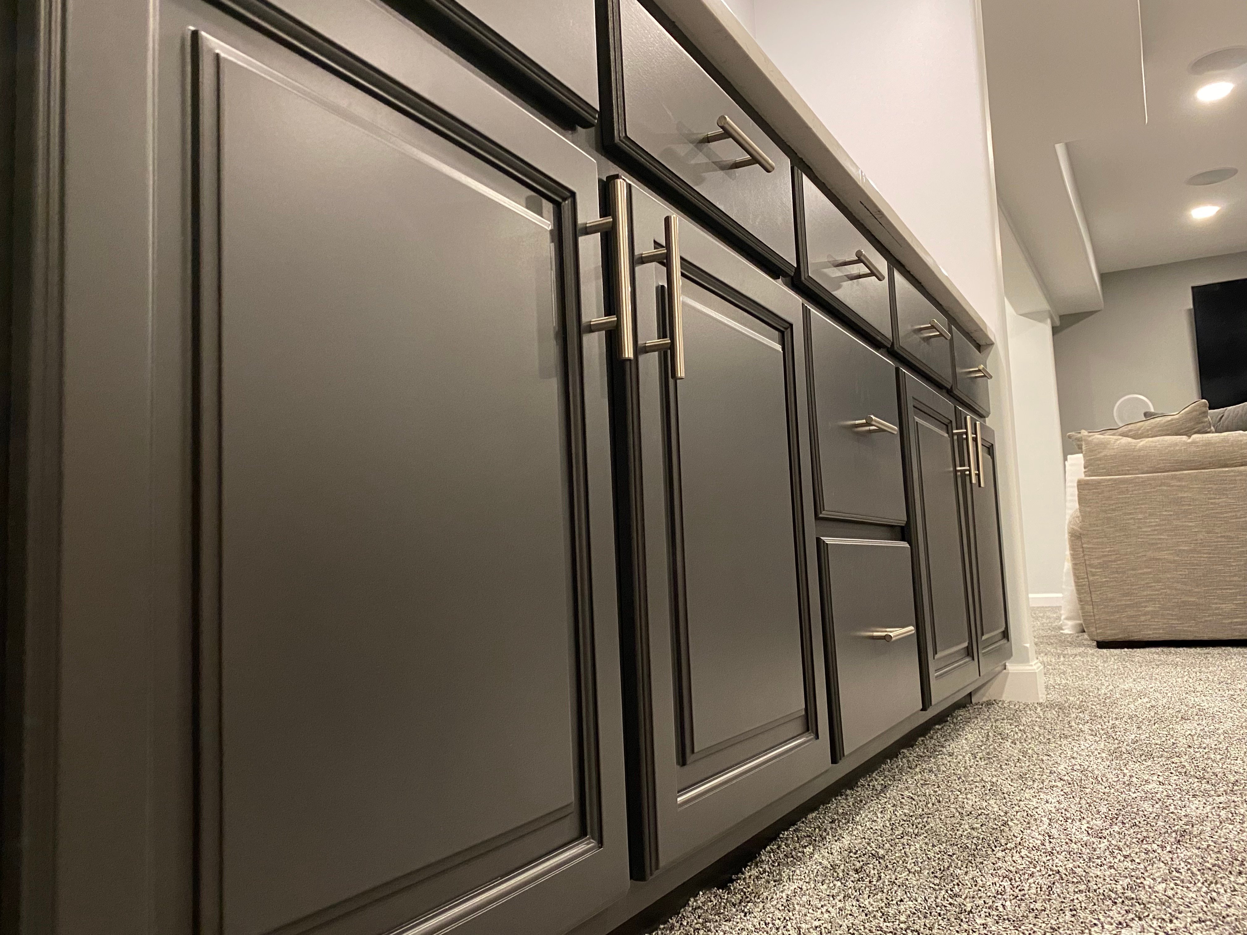 Close up of lower kitchen cabinets painted with black cabinet paint inside a Omaha home.