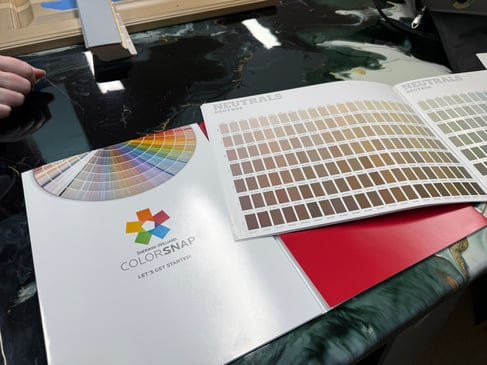 Paint book with a variety of neutral shades of paint.