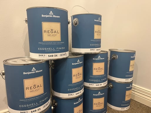 Paint gallons stacked on top of each other, Benjamin Moore Interior Regal Select paint.