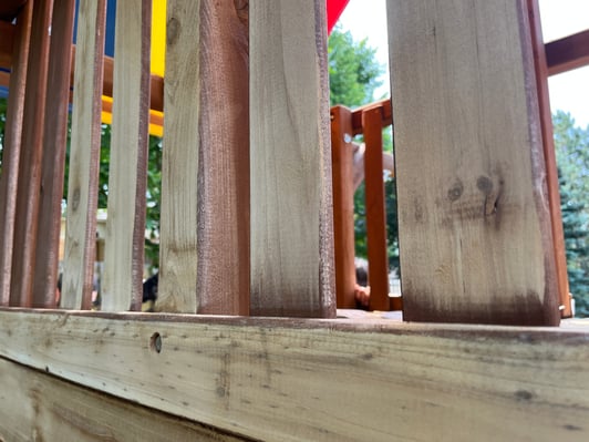 Wood playset sanded for new stain overtop.