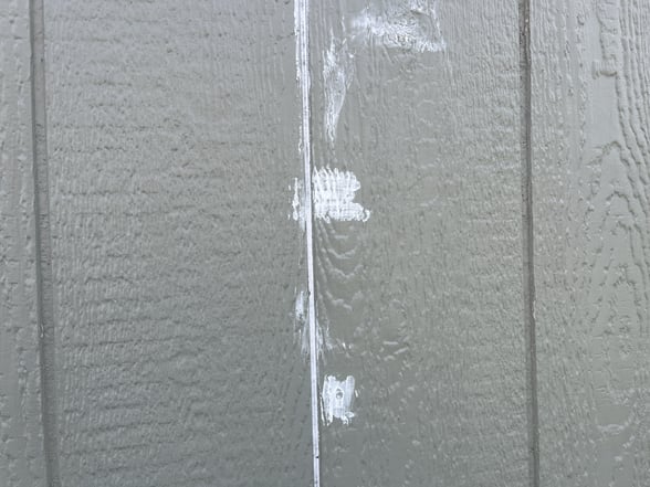 Caulk in lines on siding and nail holes.