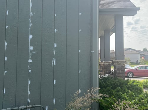 Exterior of house with caulk filled in nail holes and in seams.