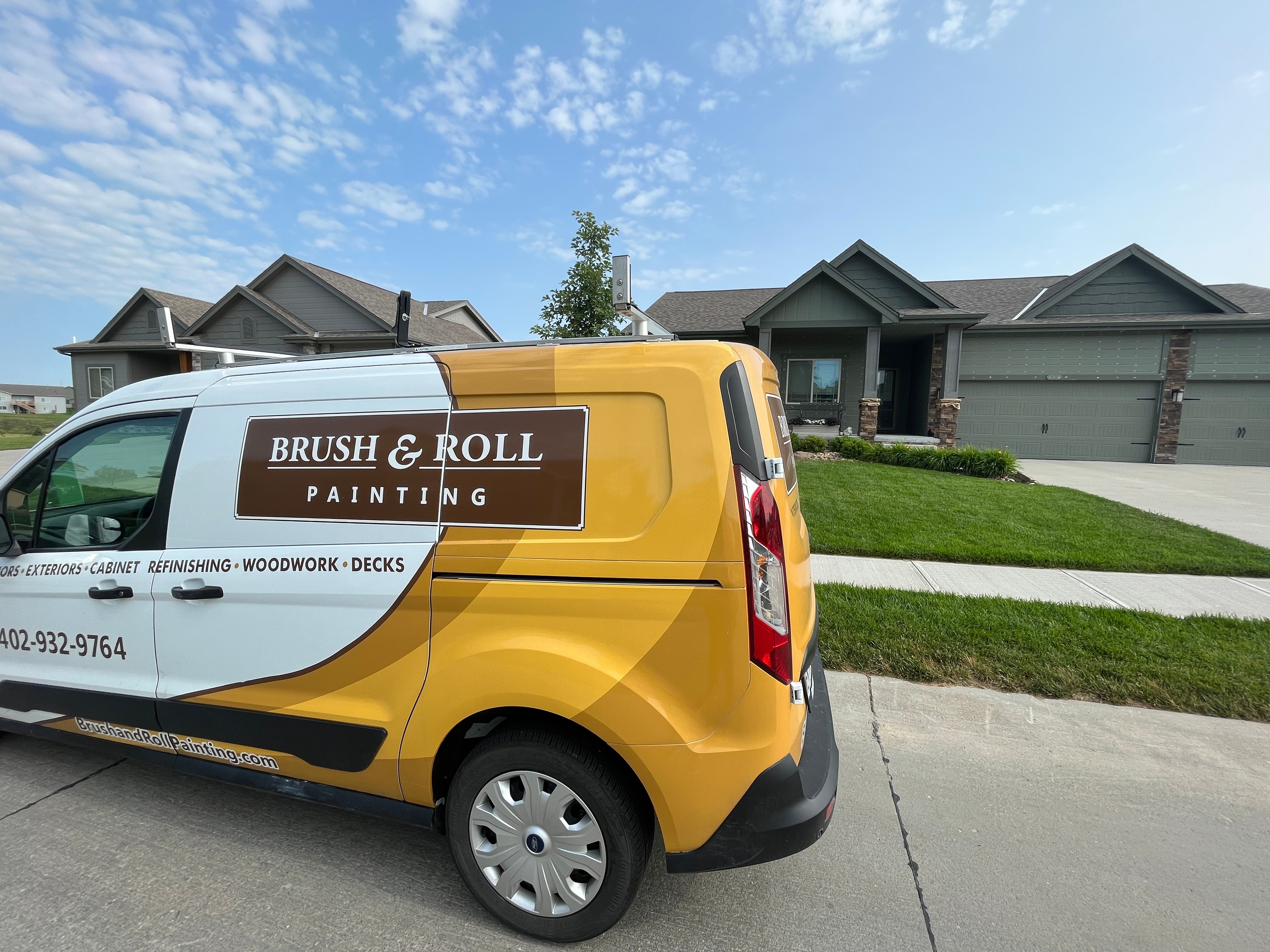 Brush & Roll Painting van parked outside of a house while exterior is being painted and prepped.