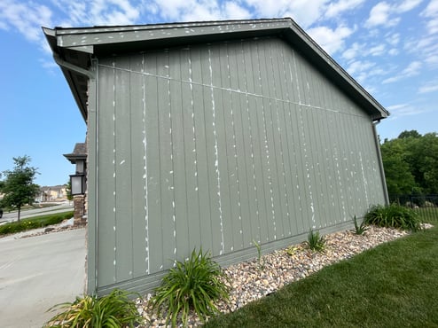 Caulk in the lines and over nail pops of the outside of a home before painting in Omaha, NE.