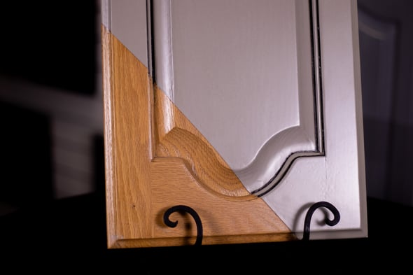 Oak cabinet door showing before and after painting and glazing with a beige color with pinstriping.