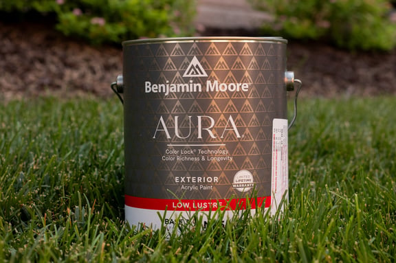 Aura by Benjamin Moore Paint Can outside of a home in the grass during a painting project on a home in Gretna, NE.