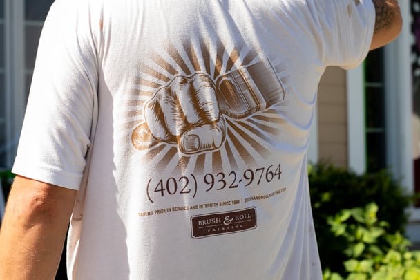 Brush & Roll Painting painter wearing a painter t shirt at a exterior home painting project in Omaha, NE.