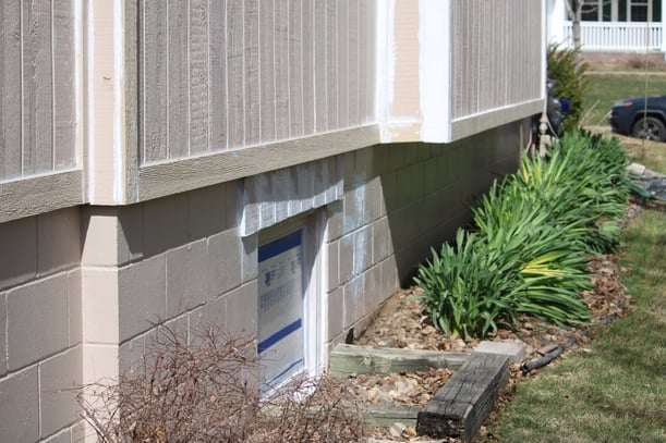 Foundation of a house prepared for paint before selling.