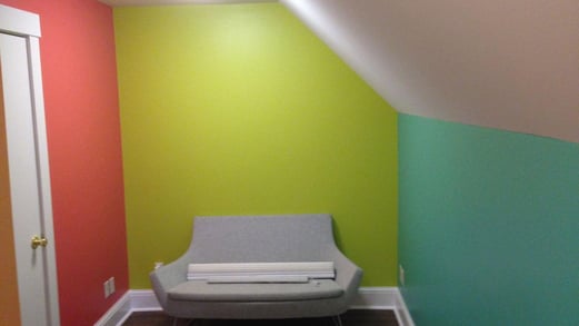 Interior space with a color on each wall. A pick, lime green, and teal.