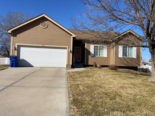 Before exterior painting a house with light brown siding.