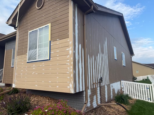 Exterior of house with primer and caulk in many areas on the exterior of a home in Omaha, NE.