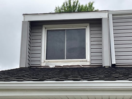 Paint peeling off of window and roofline trim in Omaha, NE.