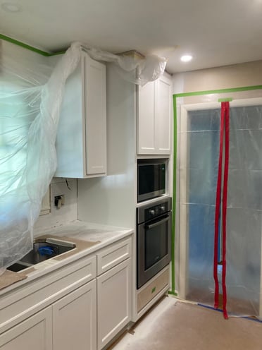 Kitchen after cabinets were sprayed white.