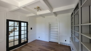 Office space with crown moldings freshly painted white and cabinets grey.