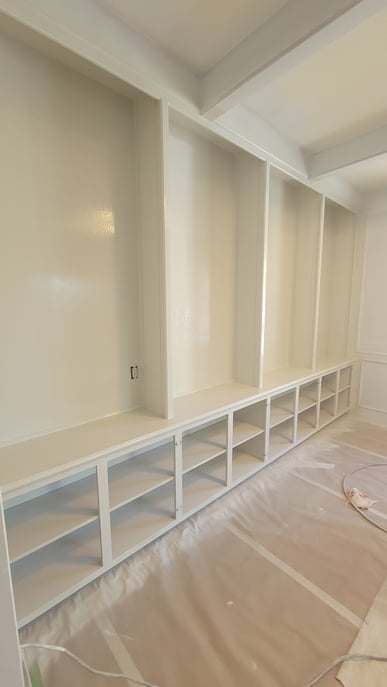 Bookshelf built in that has been sprayed with white paint in Omaha, NE.