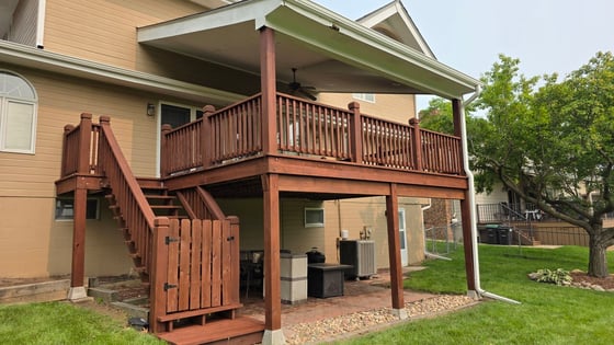Deck stain in a warm brown color on the backside of a home in Omaha, NE.