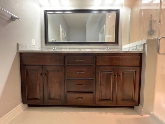 Cabinet bathroom vanity after being refinished and stained a dark brown color.