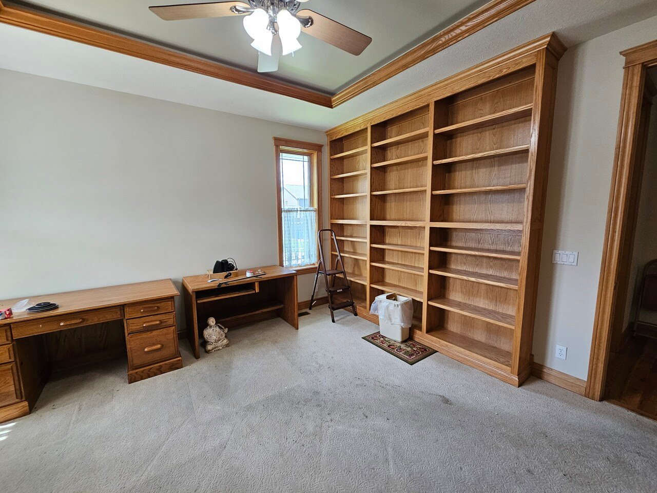 Golden oak trim and built in shelving after being painted with a clear coat on it in a home in Papillion, NE.