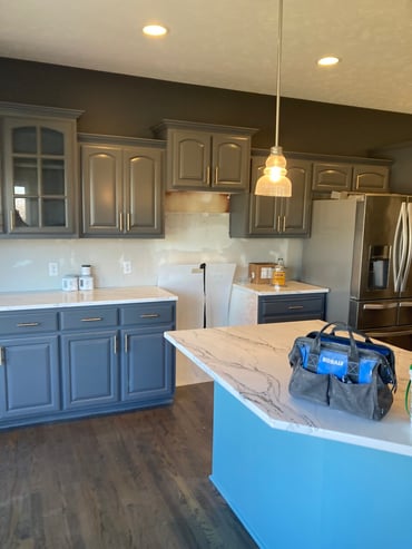 Dark paint grey and blue paint color on back walls and light blue on kitchen island.