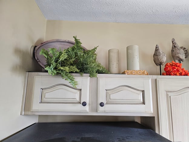 Wood cabinet doors painted white and glazed with a brushed on stain.