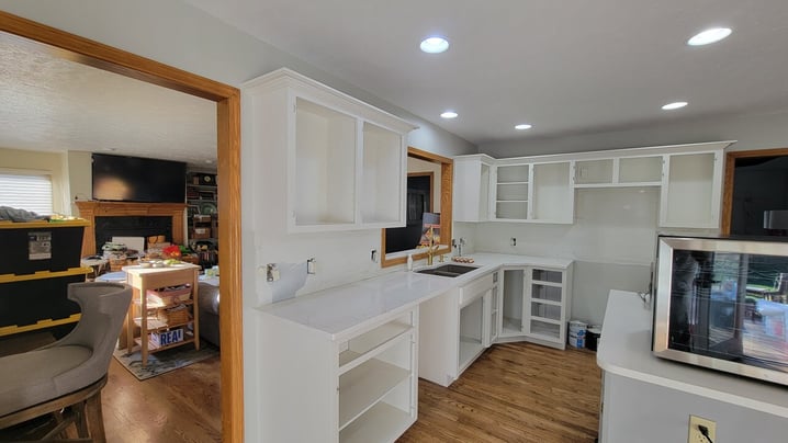 Empty cabinet boxes painted white with no doors.