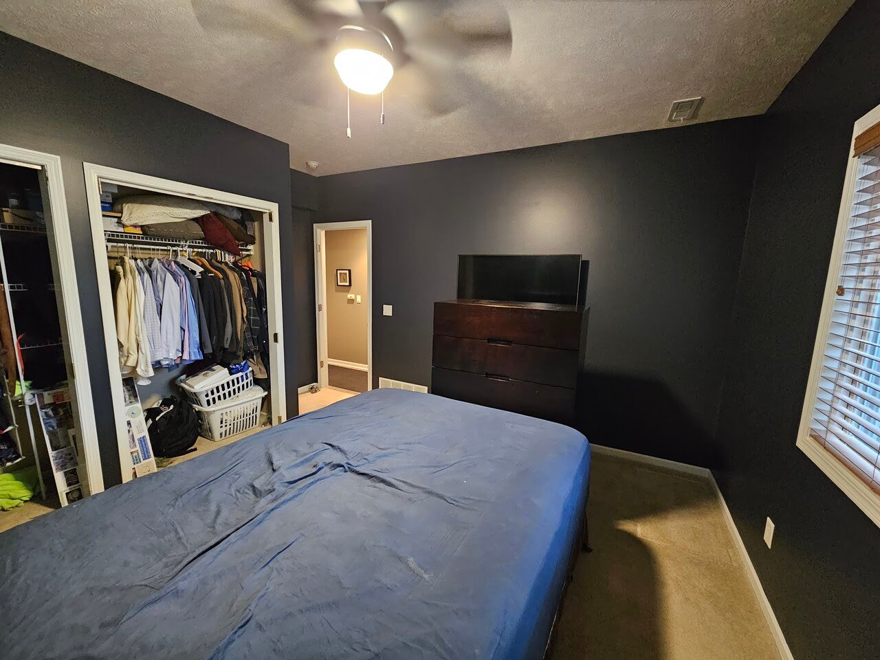 Bedroom painted black with white trim in Omaha, NE.