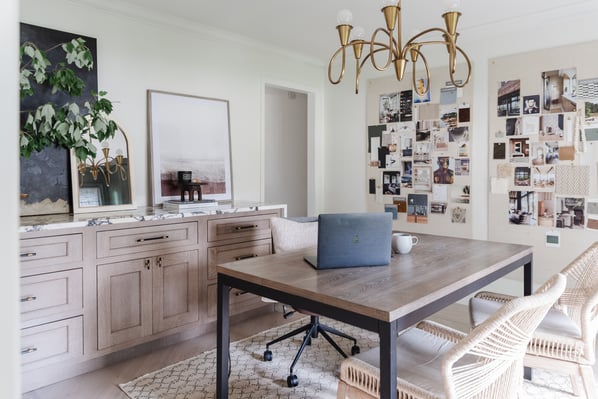 Office space with artwork hung on freshly painted white walls.