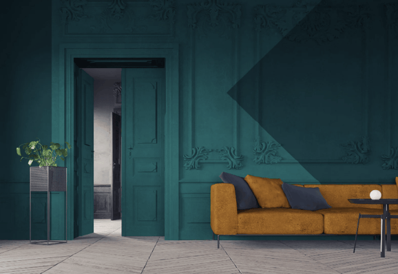 Walls trim and baseboard painted a dark blue emerald green color in a living room.