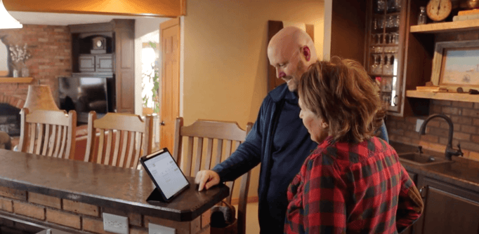 Bill Carlson, owner of Brush & Roll Painting going over a interior painting estimate with a homeowner.